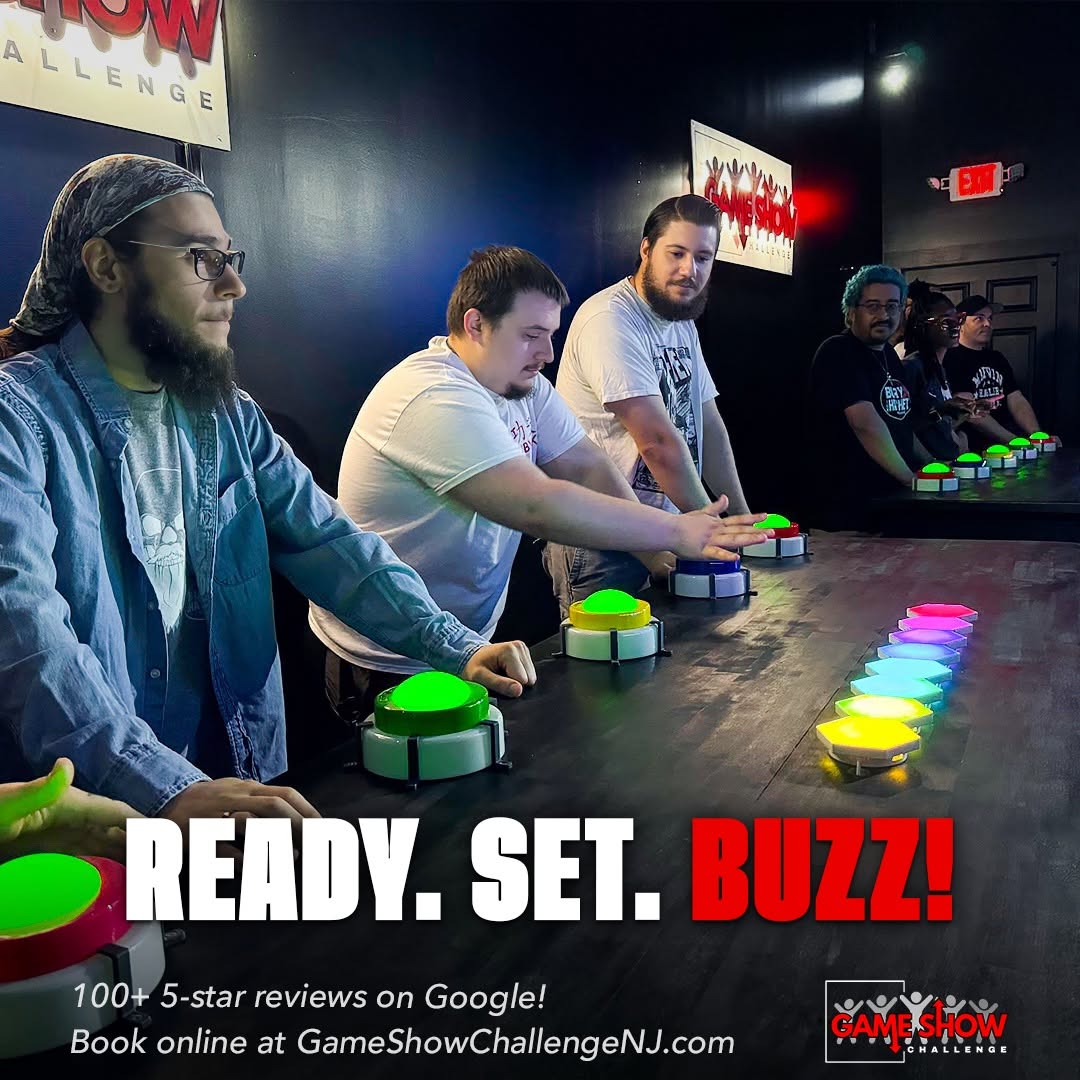 People playing Buzz! game show at a bar, with colorful buttons and a dark background.
