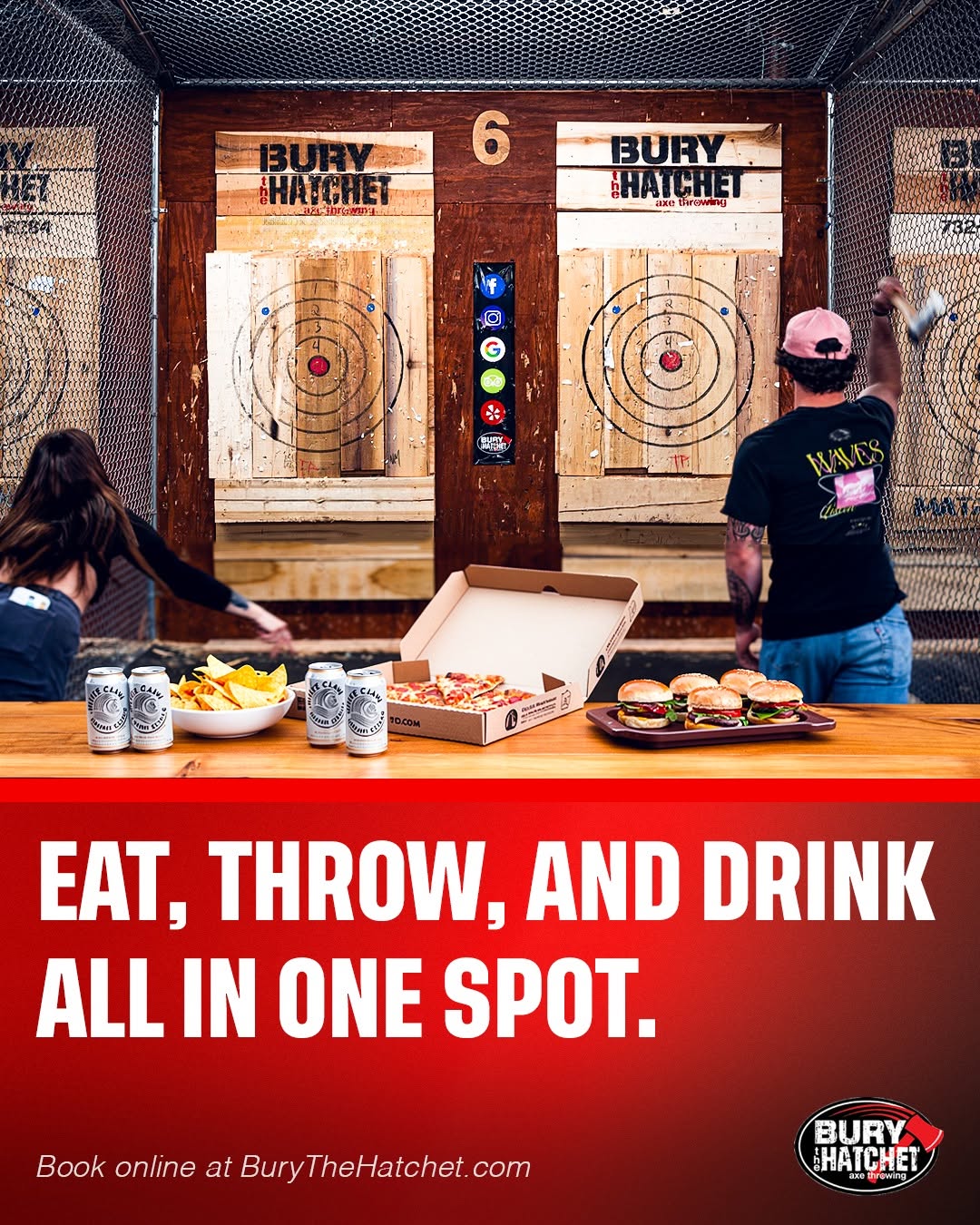 Indoor axe-throwing area with two targets, people preparing to throw axes, and food on a table, with a red banner promoting eating, throwing, and drinking.