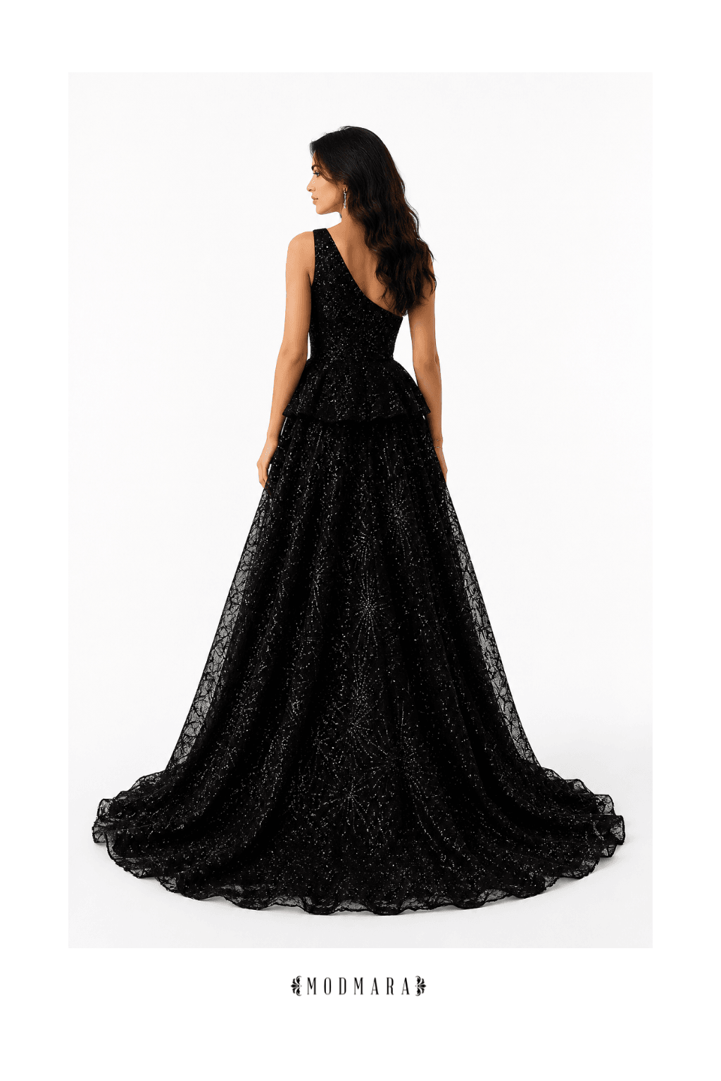 Woman in a long, black, sparkly gown, facing sideways with her back visible, against a white background.