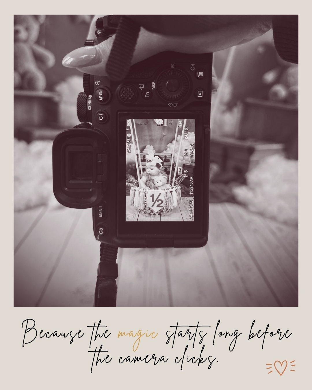 Camera viewfinder showing a birthday cake with candles, with a blurred background. Hand holding the camera above the scene.